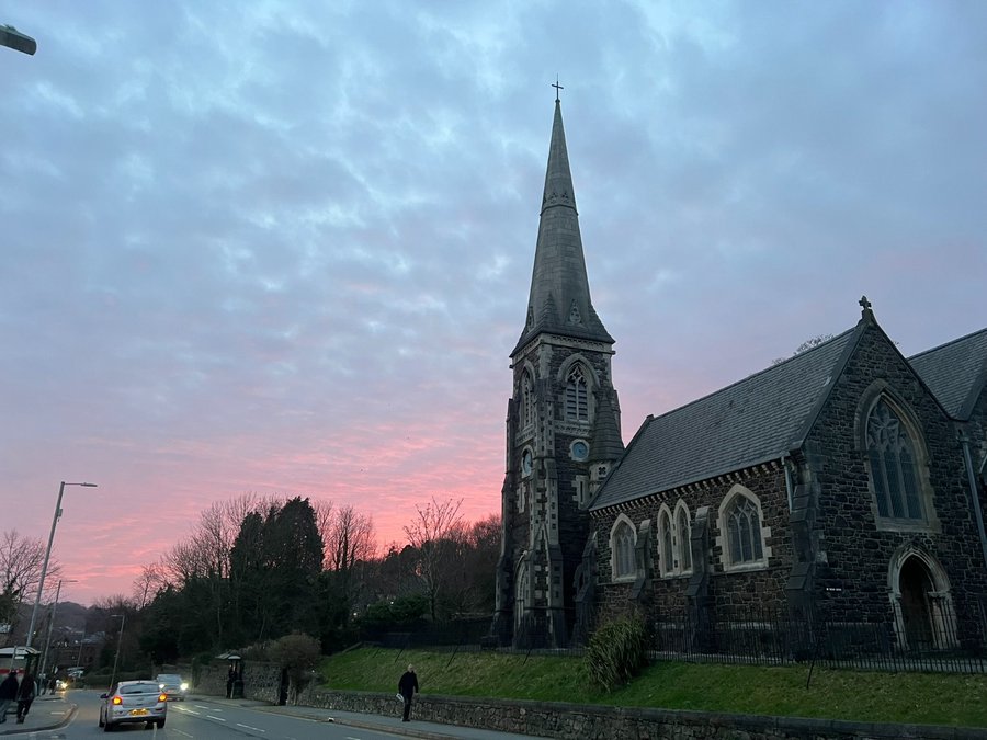 The church spire against a pink evening sky
