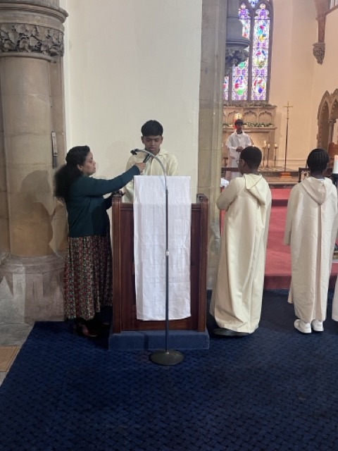 Altar servers standing near the sanctuary during the Family Eucharist