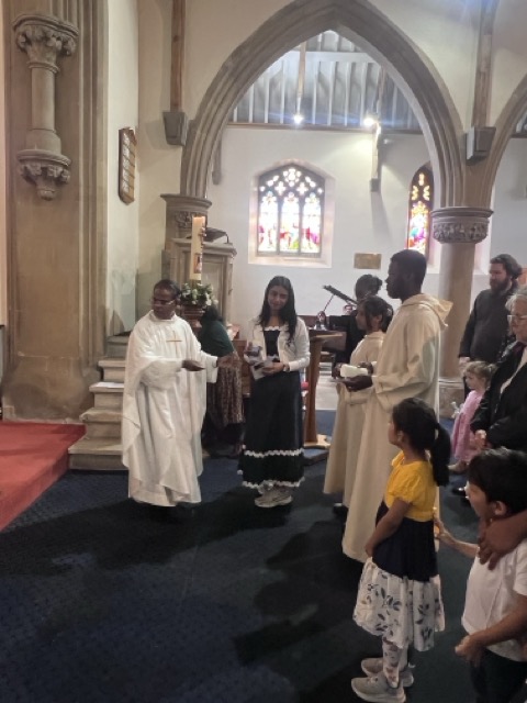 The priest distributing Communion to parishioners