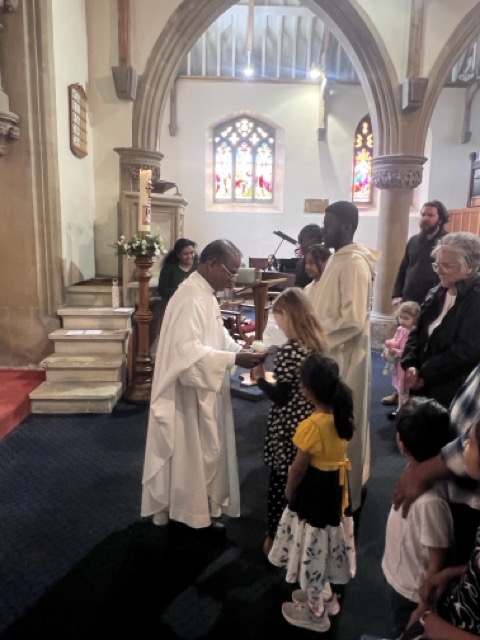 Children and adults receiving Communion during Family Eucharist