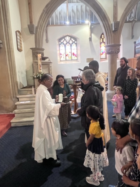 The Communion procession continuing inside the church