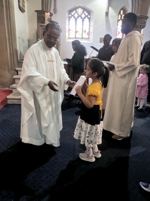 A communicant receiving during the Family Eucharist