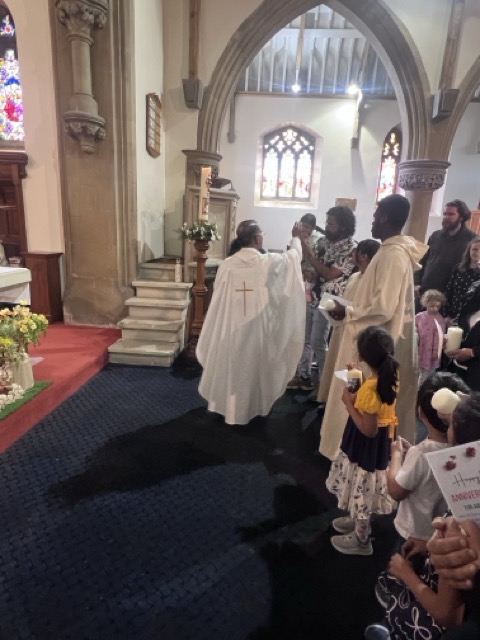 The priest distributing Communion to members of the parish