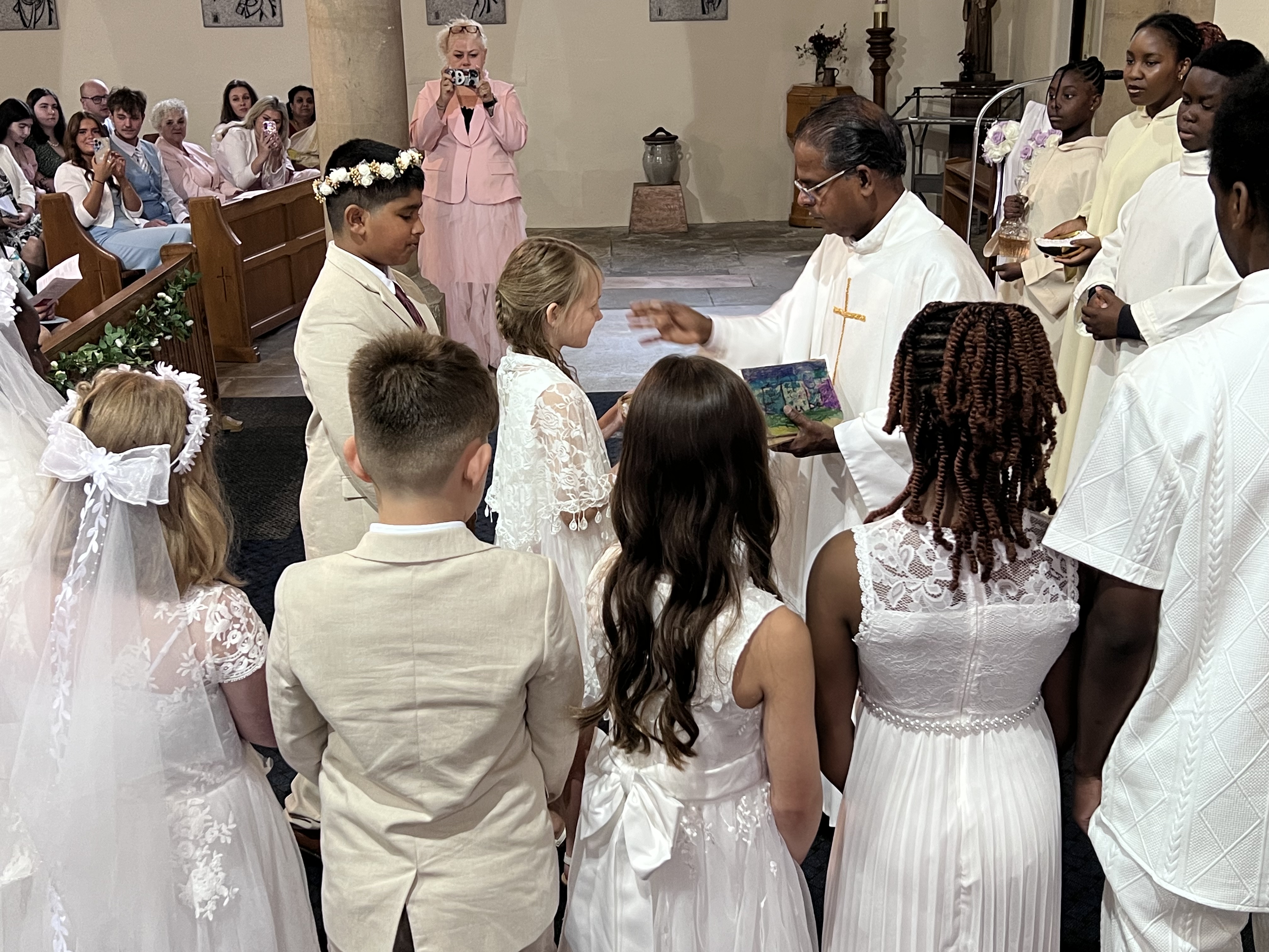 Fr. Savi with the children during the ceremony