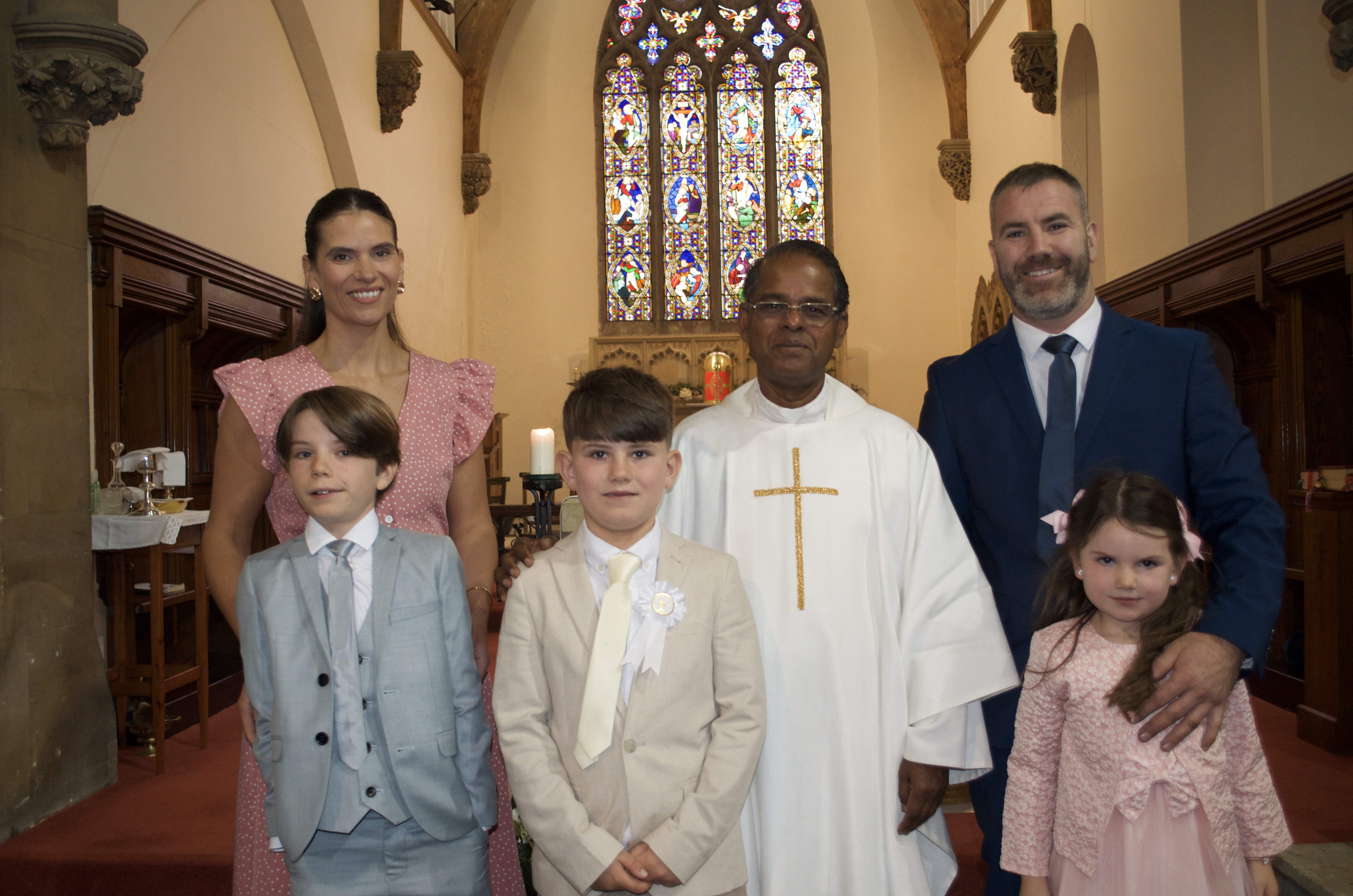 A family with Fr. Savi after First Holy Communion