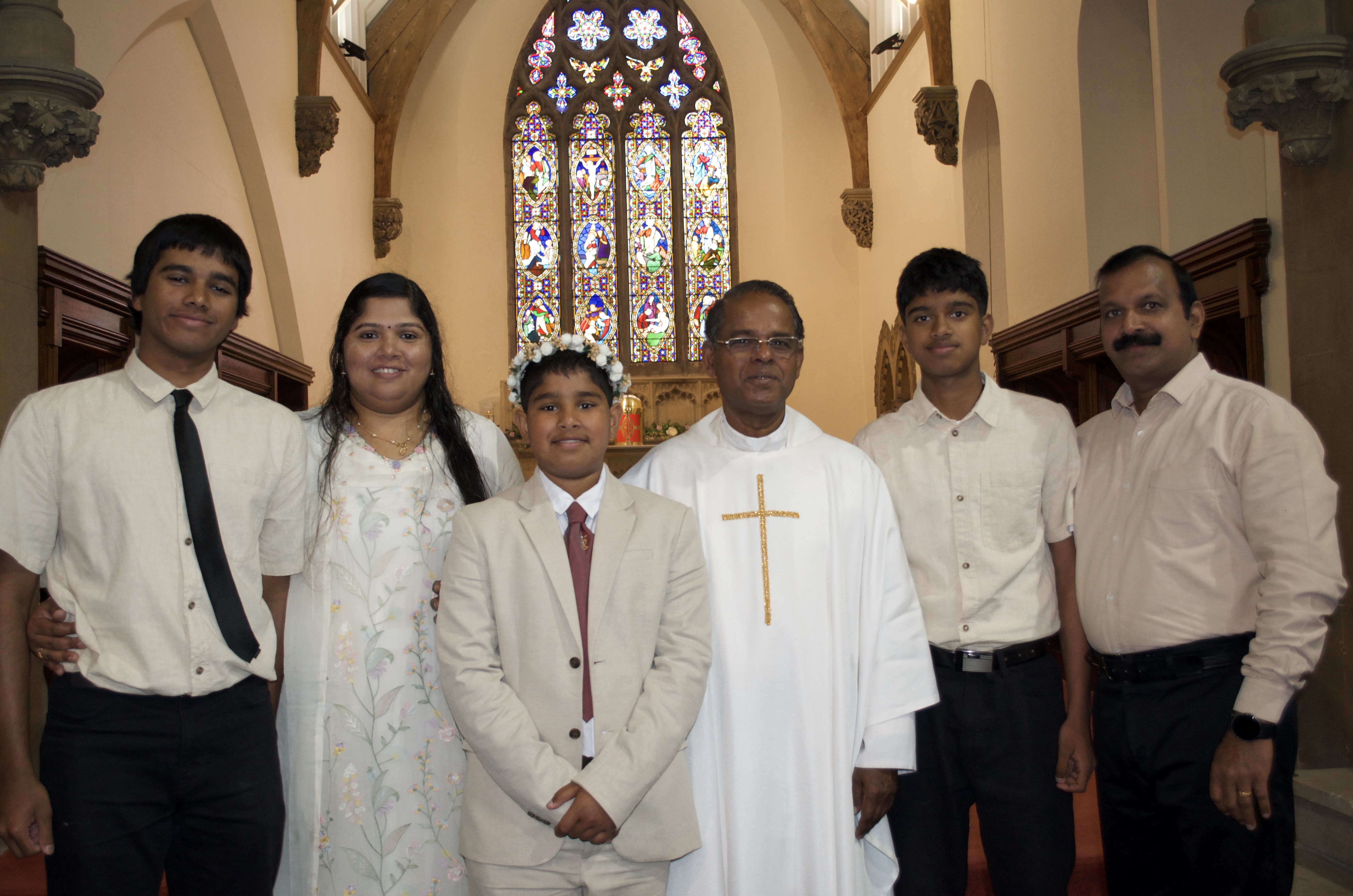 A family with Fr. Savi after First Holy Communion