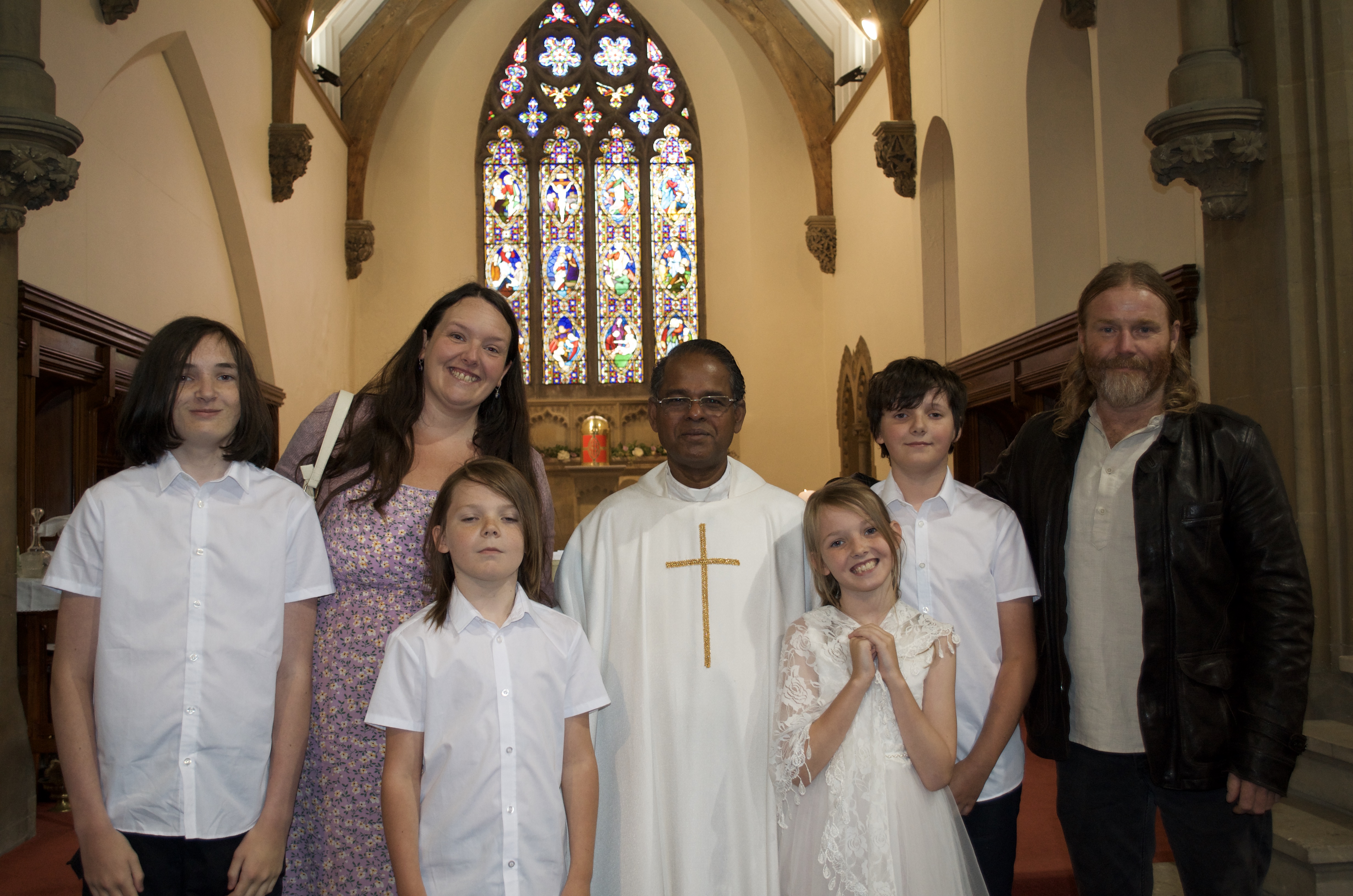 A family with Fr. Savi after First Holy Communion