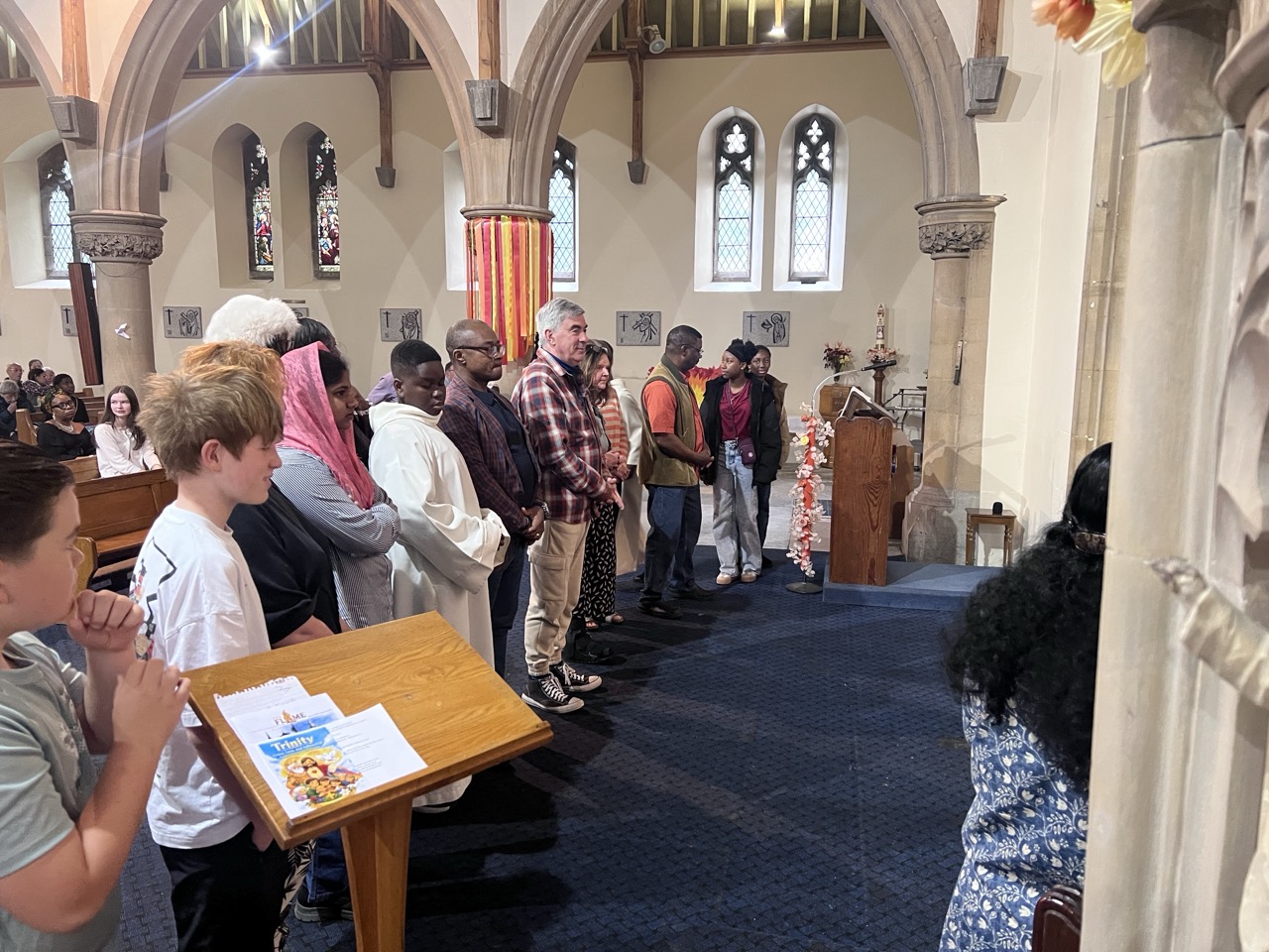 Young people and families standing in the aisle