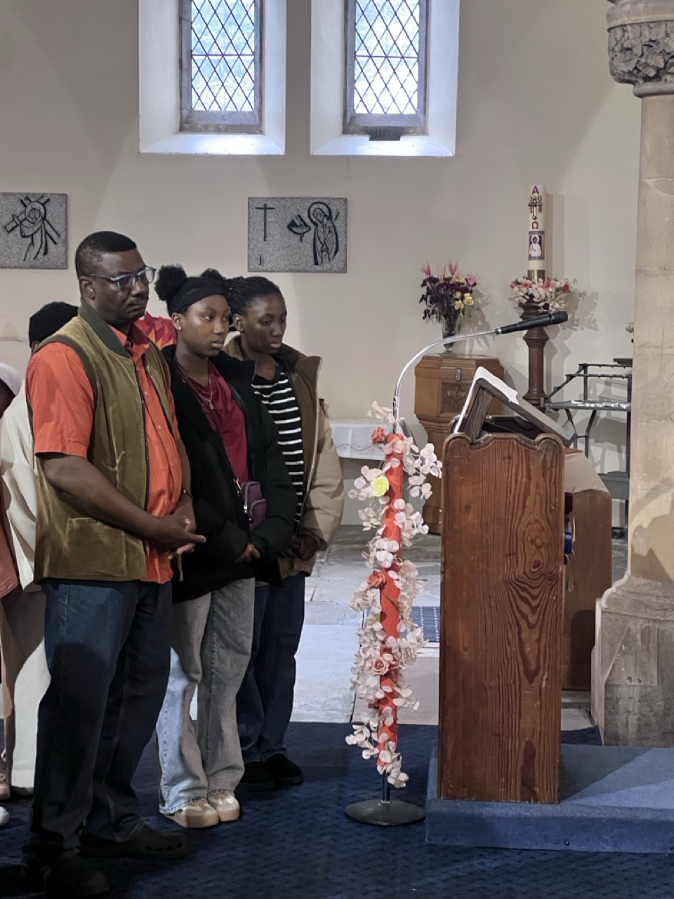 Parishioners in reverential pose near the sanctuary