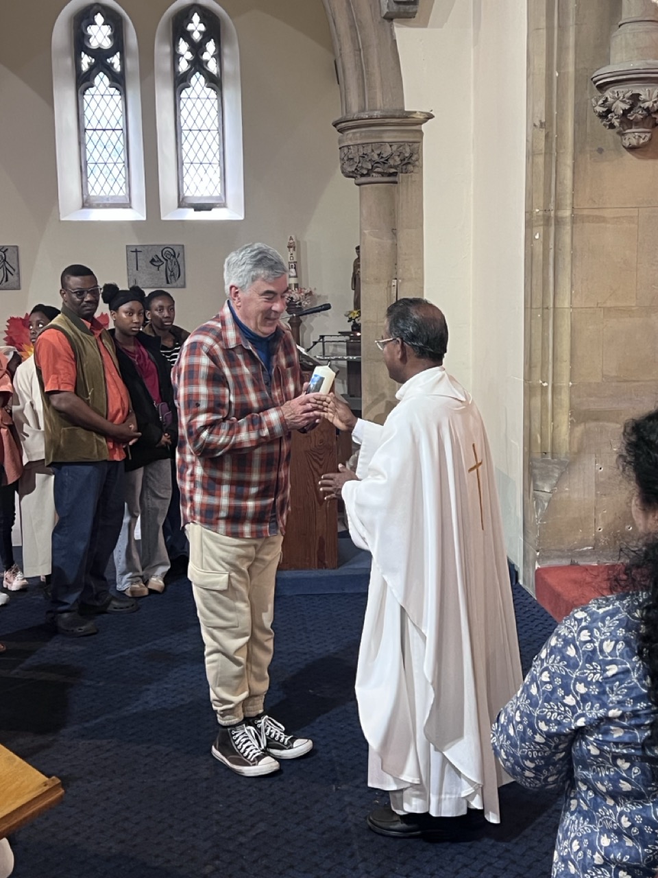 Fr. Savi distributing candles along the line