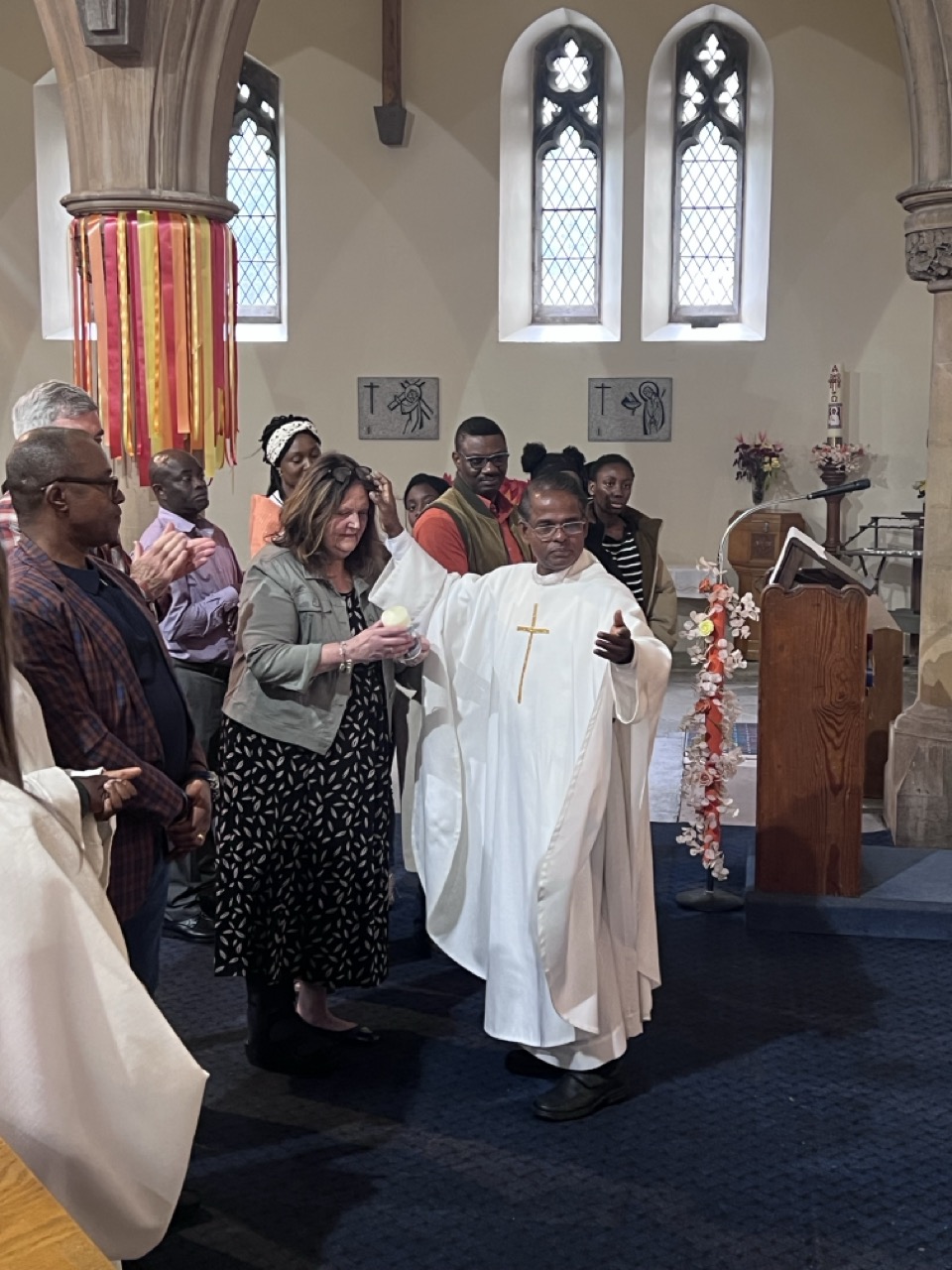 Fr. Savi blessing a parishioner with a candle