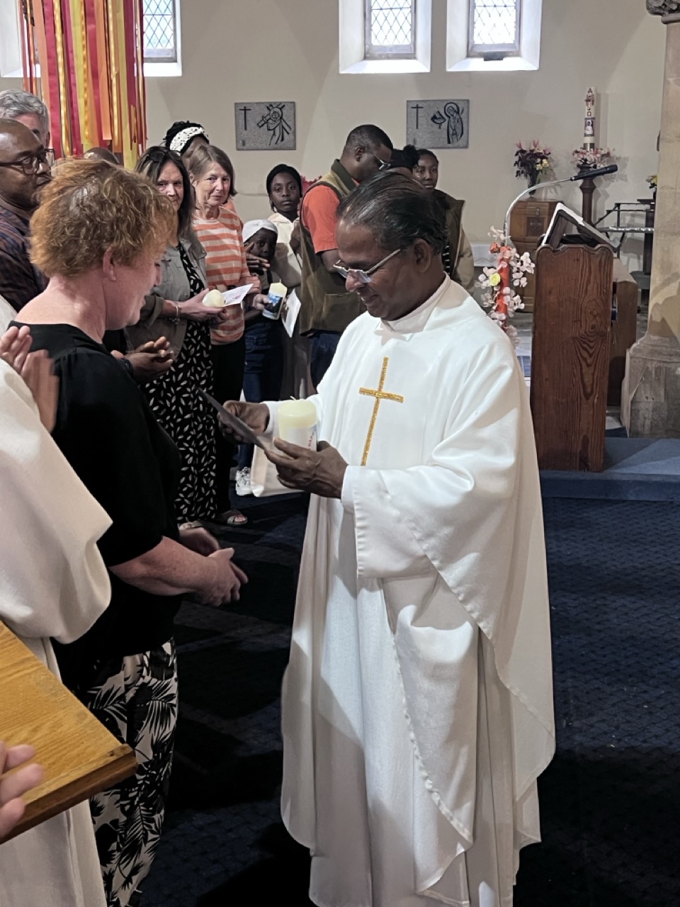 Fr. Savi with a young parishioner, smiling